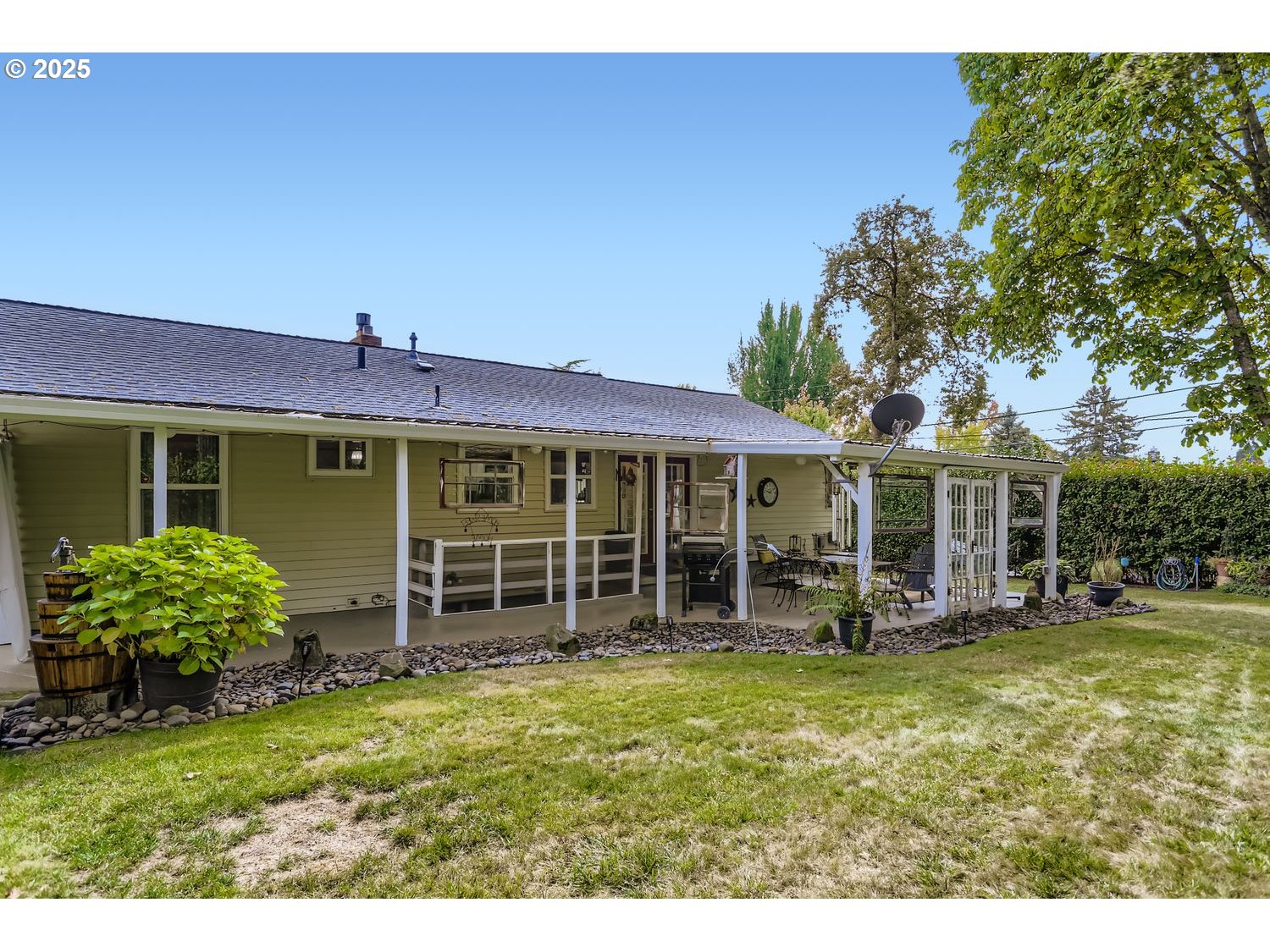 4711 Southeast Roethe Road Milwaukie, OR 97267 - Photo 28 of 30 a front view of a house with a garden and porch