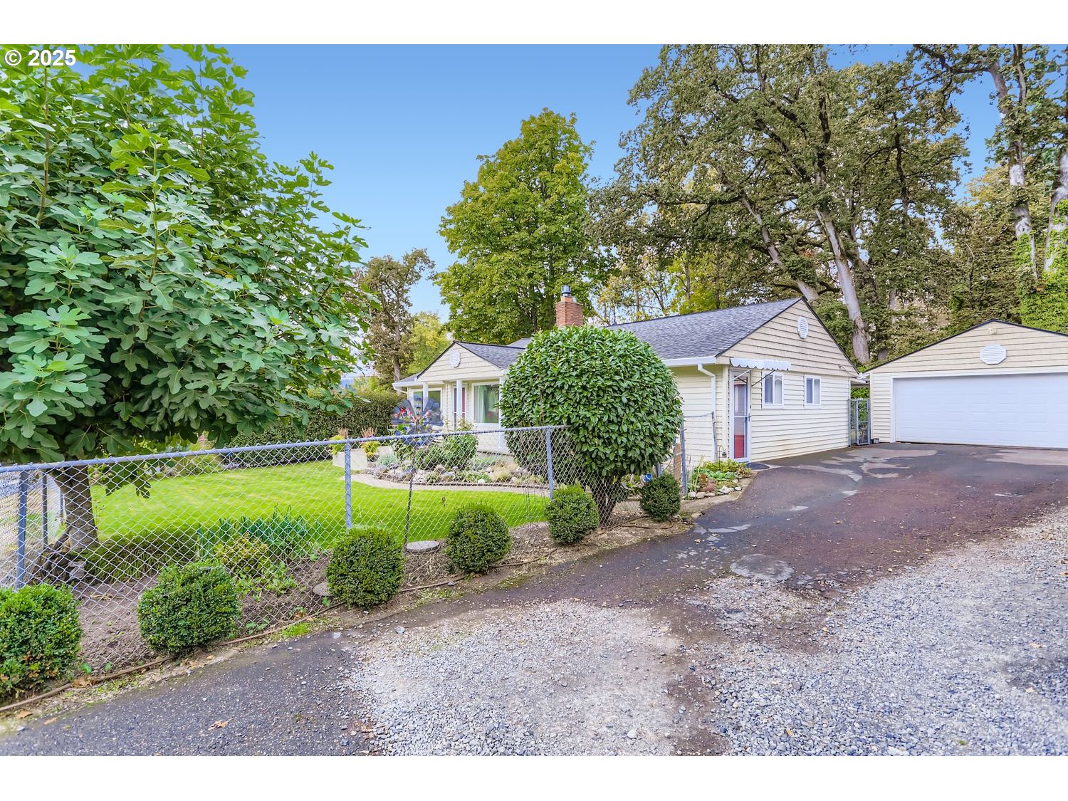 4711 Southeast Roethe Road Milwaukie, OR 97267 - Photo 4 of 30 a view of a house with a yard and a large tree
