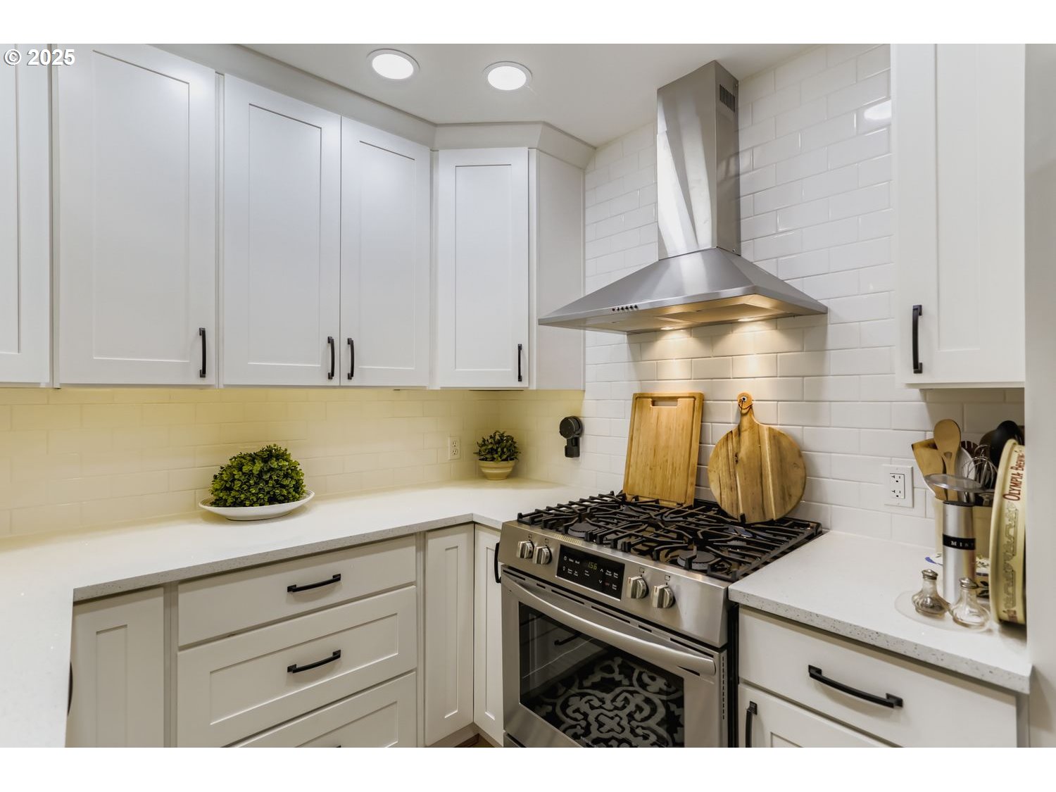 4711 Southeast Roethe Road Milwaukie, OR 97267 - Photo 10 of 30 a kitchen with a stove and white cabinets