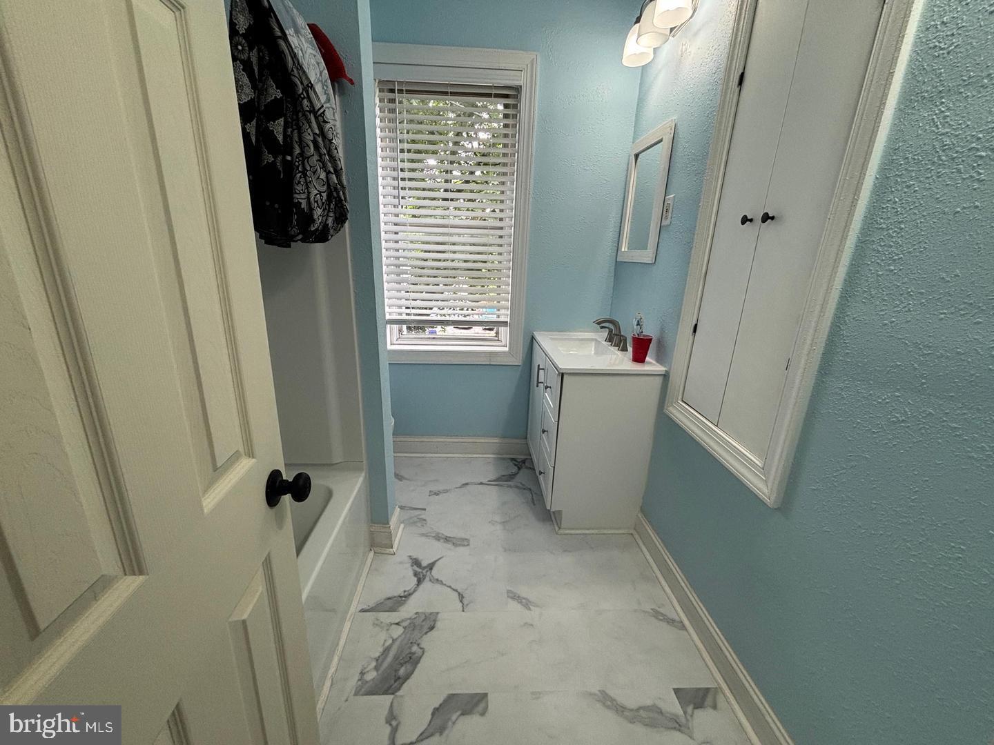 130 East 4th Street, Unit 2 Pottstown, PA 19464 - Photo 7 of 16 a bathroom with a sink a window and shower