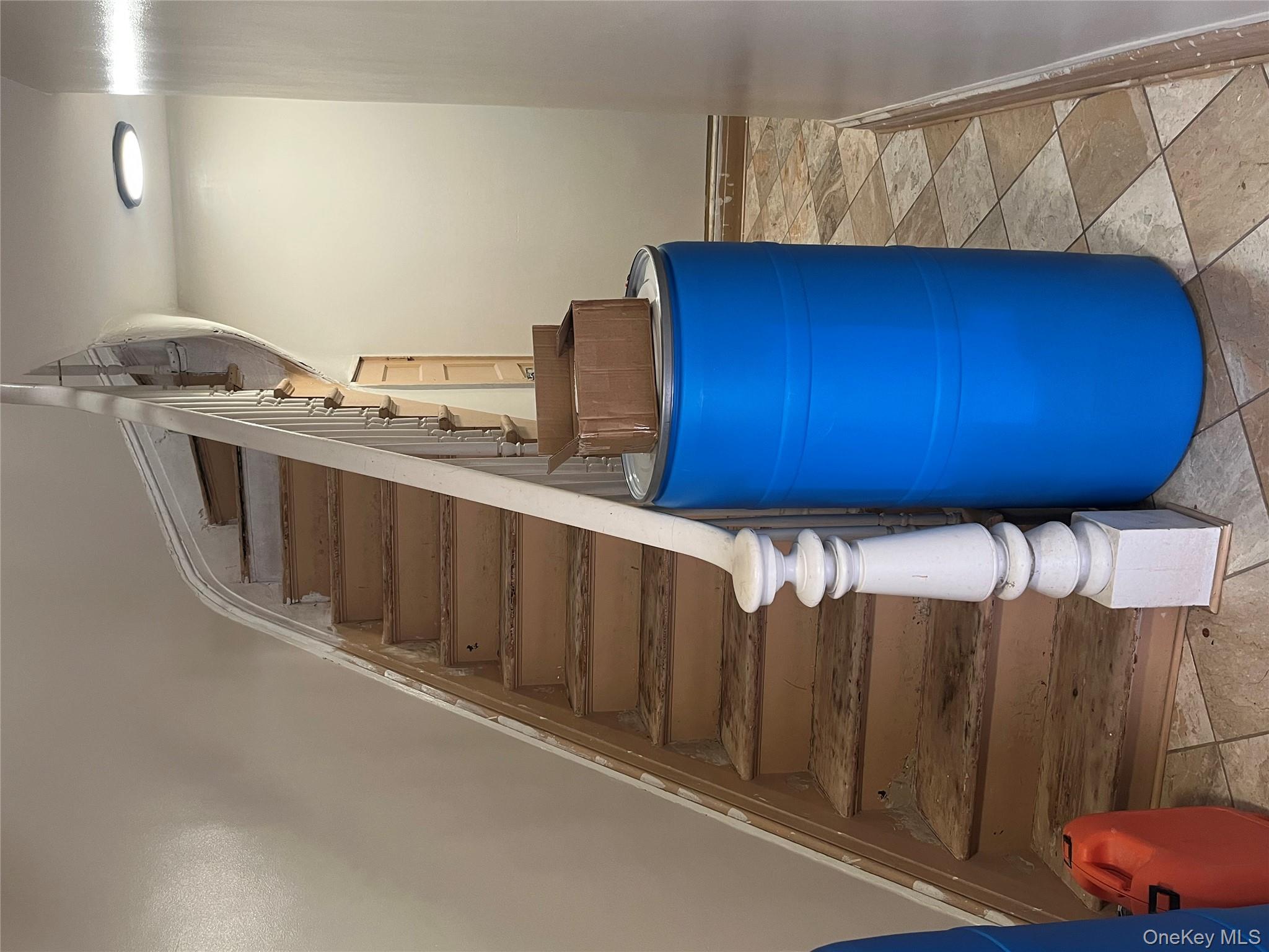 149 West Kingsbridge Road Mount Vernon, NY 10550 - Photo 13 of 25 Stairway featuring baseboards and stone tile floors