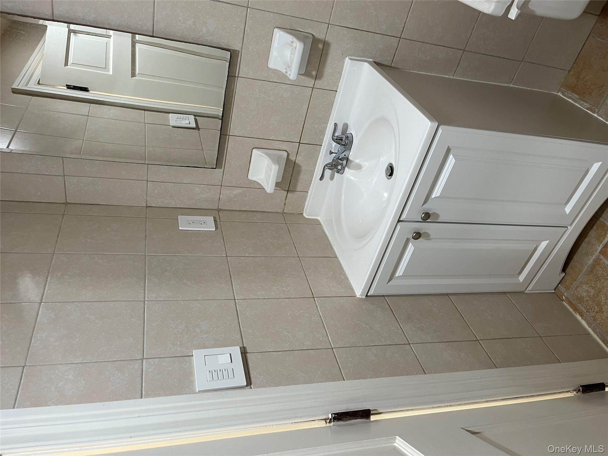 149 West Kingsbridge Road Mount Vernon, NY 10550 - Photo 19 of 25 Bathroom with vanity and tile walls