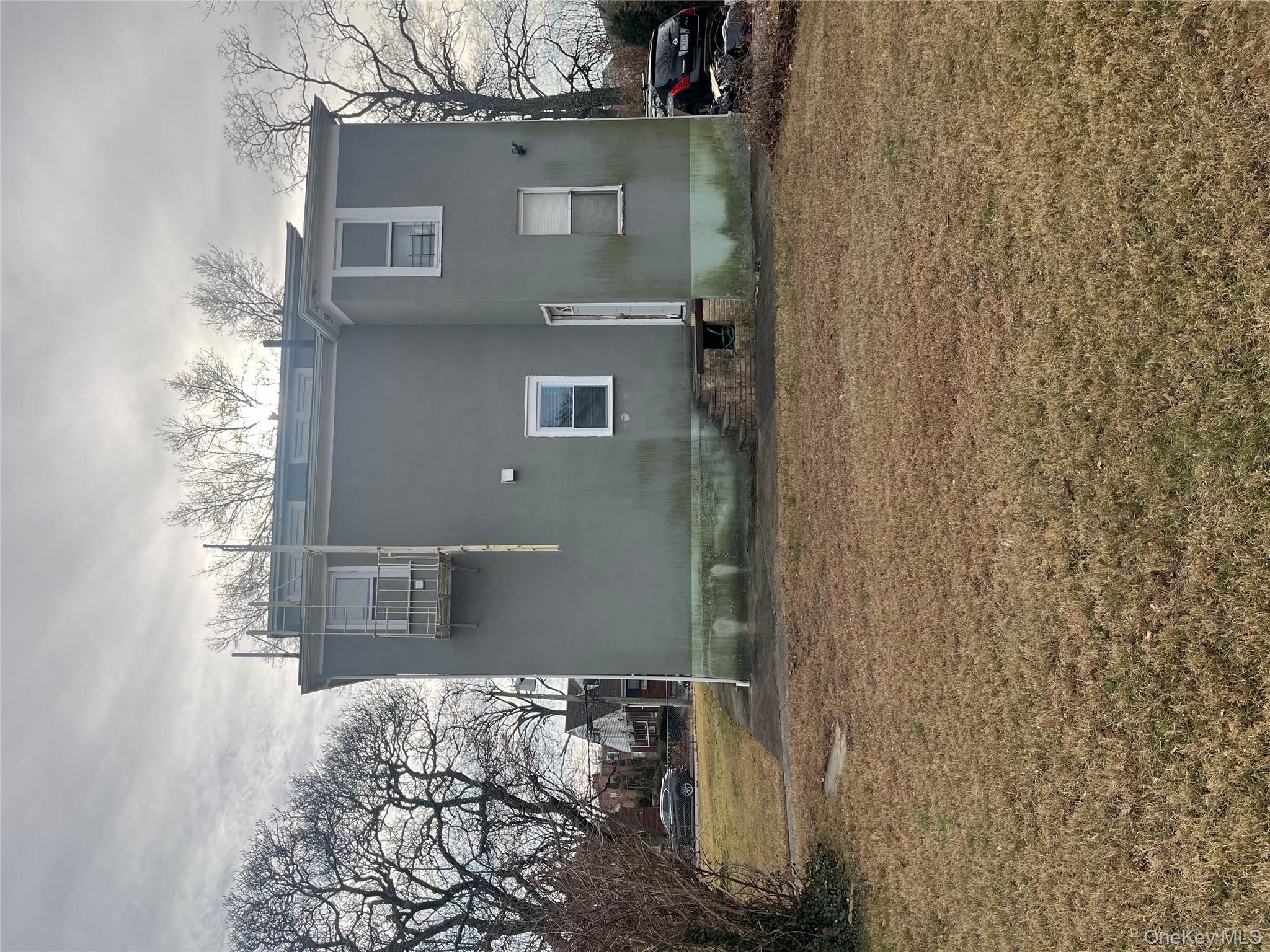 149 West Kingsbridge Road Mount Vernon, NY 10550 - Photo 3 of 25 Rear view of property featuring a yard
