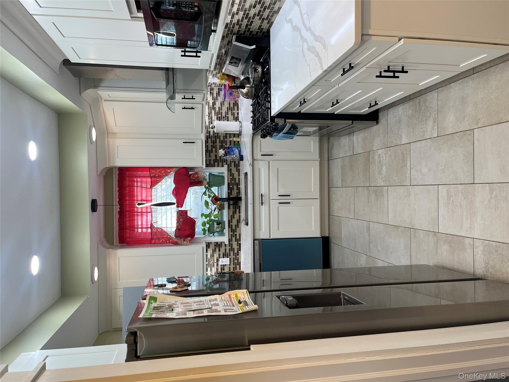 149 West Kingsbridge Road Mount Vernon, NY 10550 - Photo 7 of 25 Kitchen featuring range, white cabinets, refrigerator, range hood, and dishwashing machine
