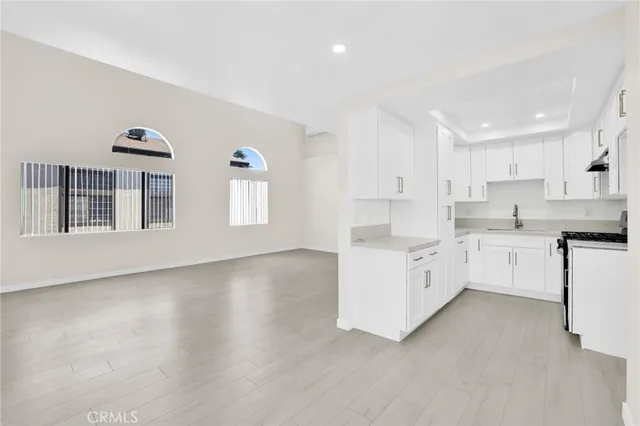 a kitchen with white cabinets and white appliances
