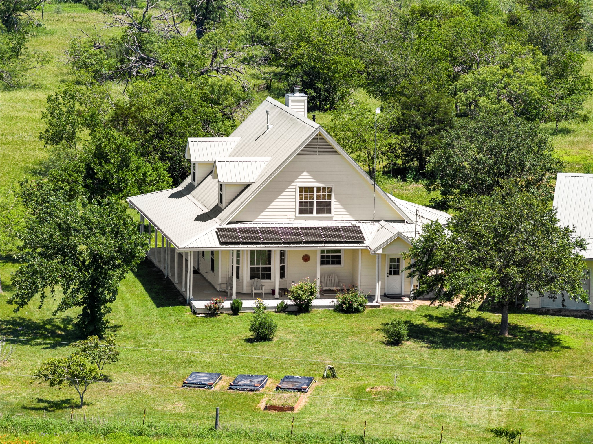 928 Upper Elgin River Road Elgin, TX 78621 - Photo 3 of 40 Featuring 1,634 square feet, 3 bedrooms, and 2 bathrooms, the home welcomes you with a classic wraparound porch ideal for enjoying stunning sunrises and quiet Texas evenings.