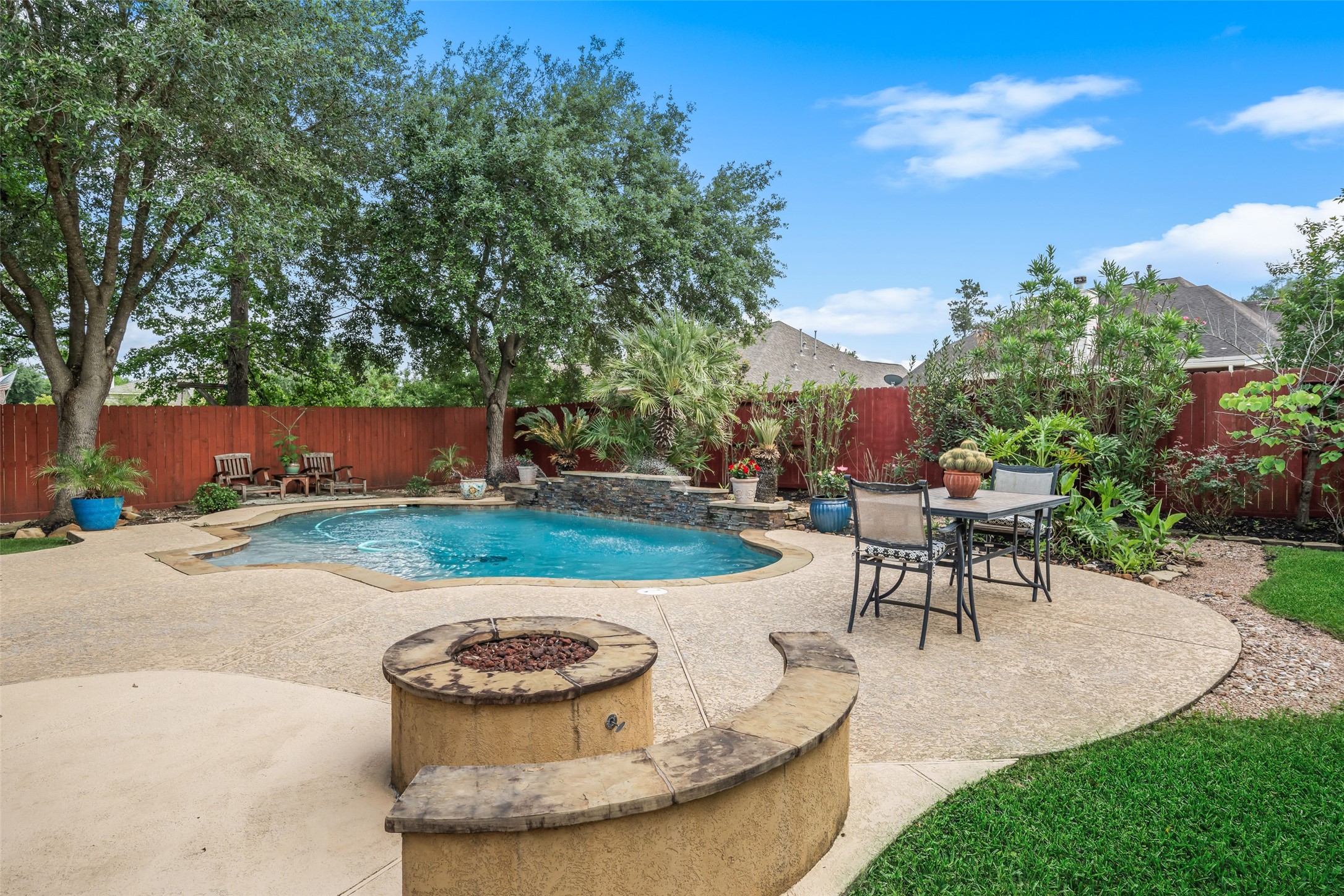 6407 Ashley Manor Drive Spring, TX 77389 - Photo 39 of 41 a view of a backyard with table and chairs potted plants and large tree