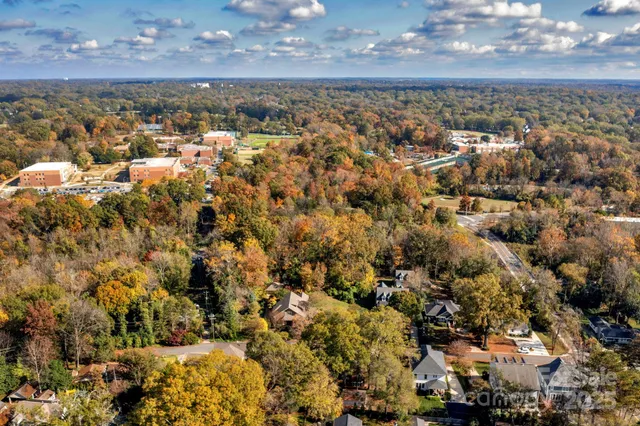 an aerial view of a house with a lake