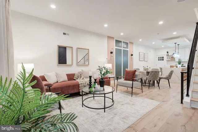 a living room with furniture and a potted plant