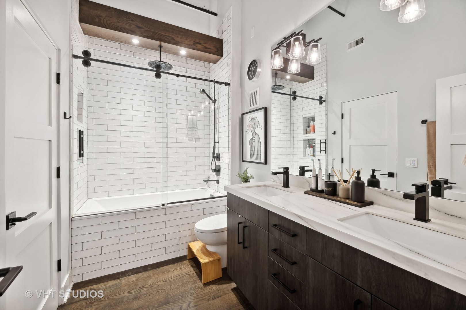 1000 West Washington Boulevard, Unit 319 Chicago, IL 60607 - Photo 11 of 15 a bathroom with double vanity sink a toilet a mirror and shower