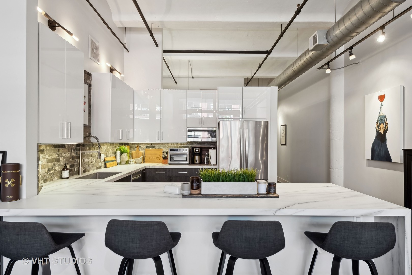 1000 West Washington Boulevard, Unit 319 Chicago, IL 60607 - Photo 6 of 15 a kitchen with a table chairs sink and cabinets
