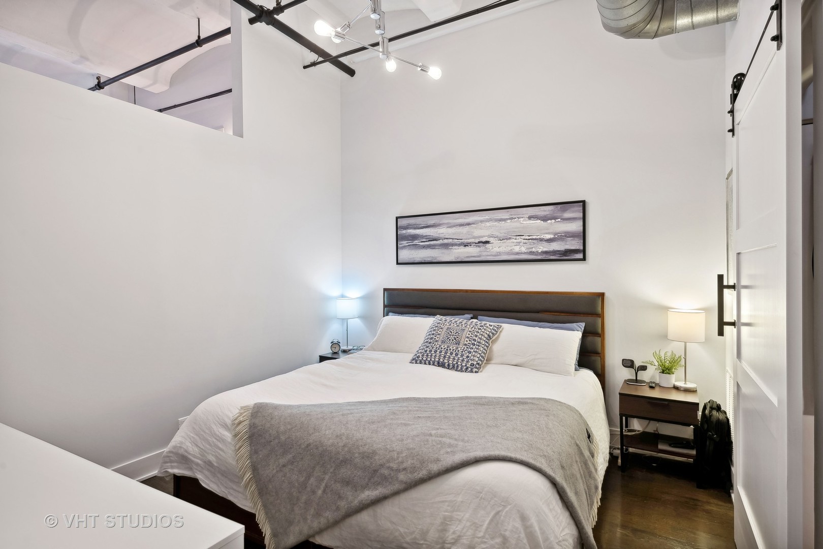 1000 West Washington Boulevard, Unit 319 Chicago, IL 60607 - Photo 10 of 15 a bedroom with a bed and a night stand