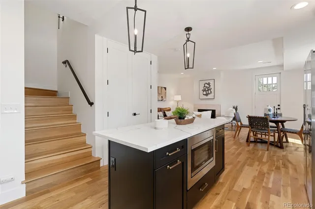 a kitchen with sink cabinets and wooden floor