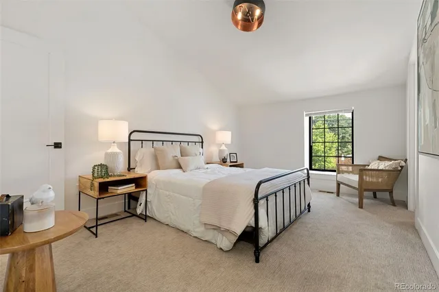 a bedroom with a bed chair and window