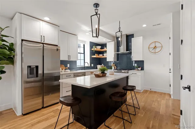 a kitchen with granite countertop a sink cabinets and stainless steel appliances