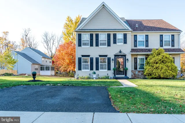 front view of a brick house with a yard