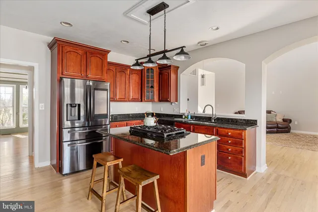a kitchen with stainless steel appliances a sink stove and refrigerator