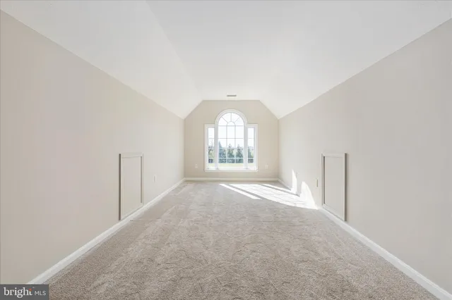 a view of walk in closet with clothes