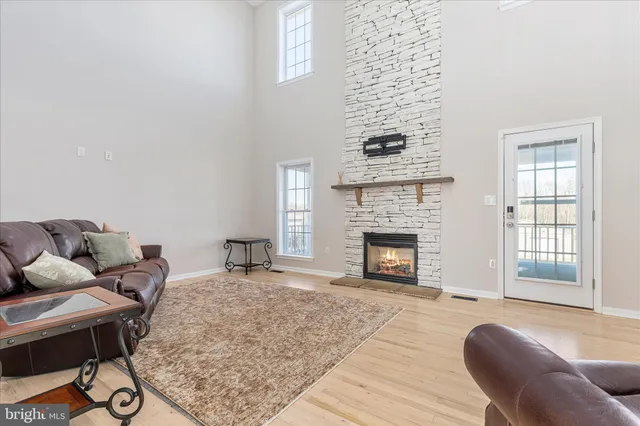 a living room with a fireplace and a fireplace