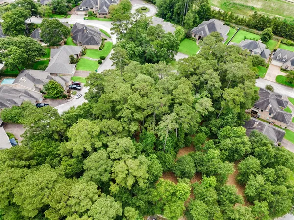 an aerial view of a house with a yard and outdoor seating