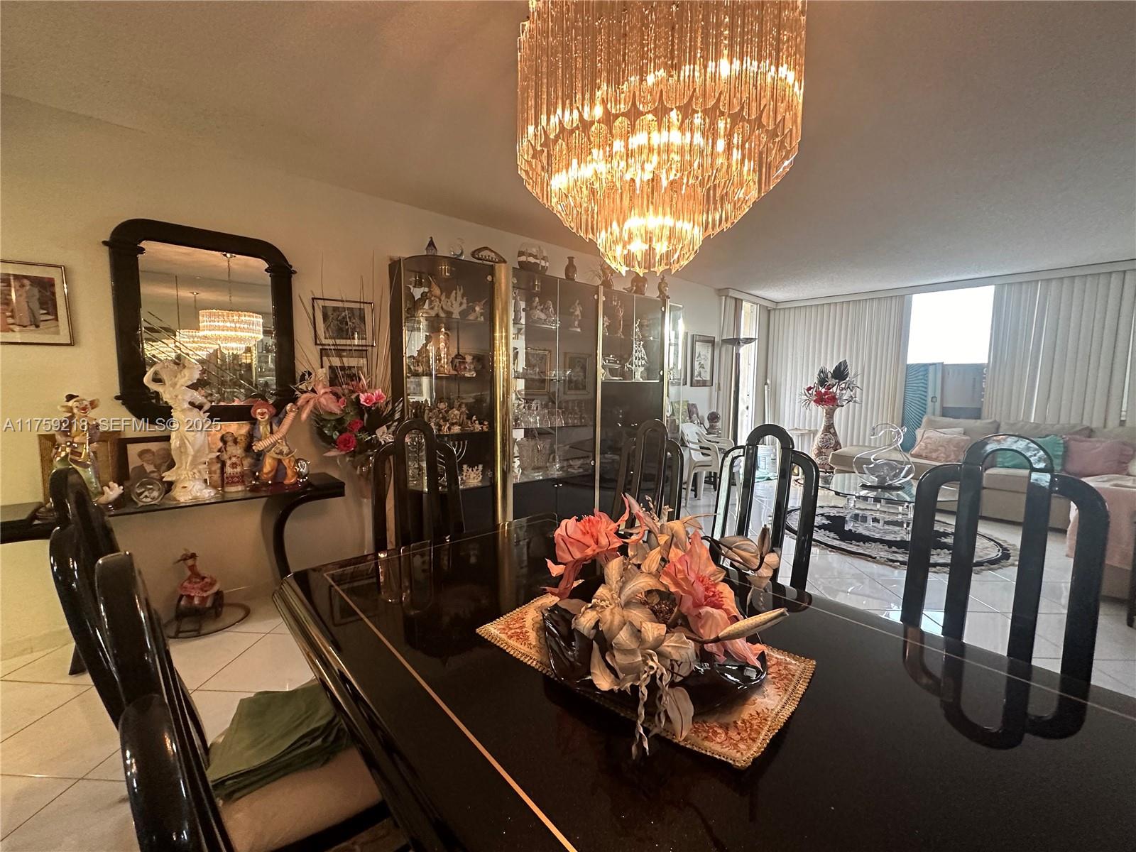 Oceanside Hallandale Beach, FL 33009 - Photo 12 of 54 a view of a dining room with furniture and chandelier