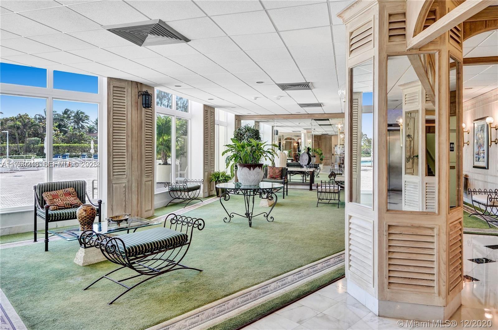 Oceanside Hallandale Beach, FL 33009 - Photo 36 of 54 a living room with patio furniture and a floor to ceiling window