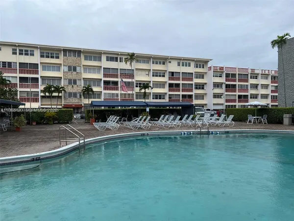a view of a swimming pool with outdoor seating
