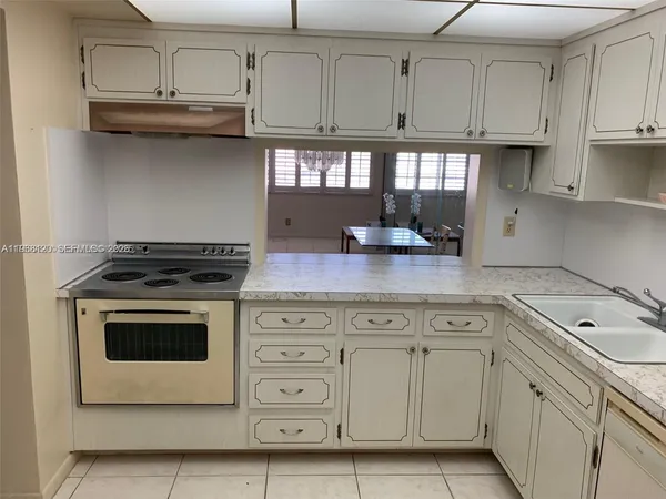 a kitchen with appliances cabinets and a counter space