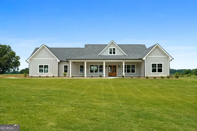 a front view of a house with a garden