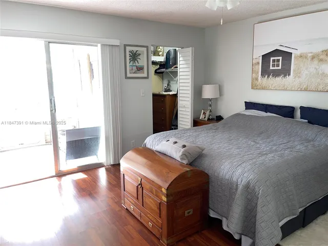 a bedroom with a bed and a glass door