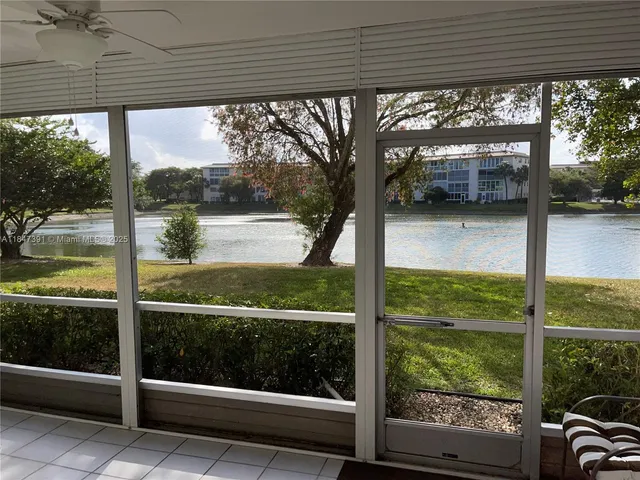 a living room with a large window and yard
