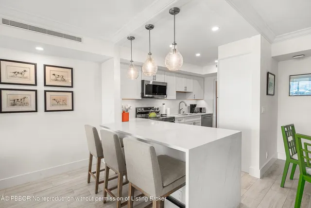 a view of kitchen with cabinets and wooden floor