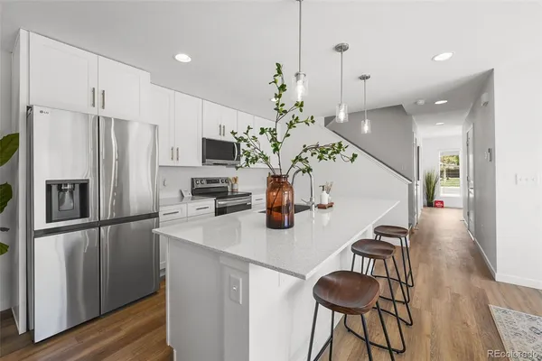 a kitchen with stainless steel appliances a refrigerator and a stove