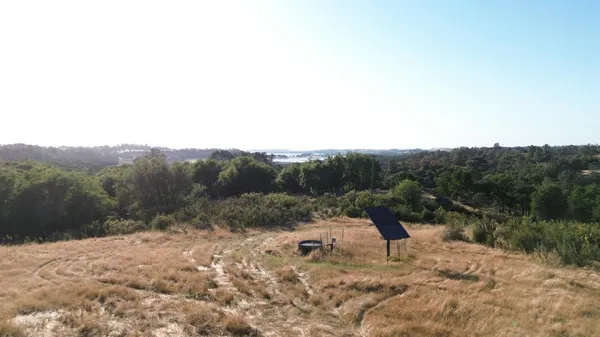a view of a lake with houses in the back