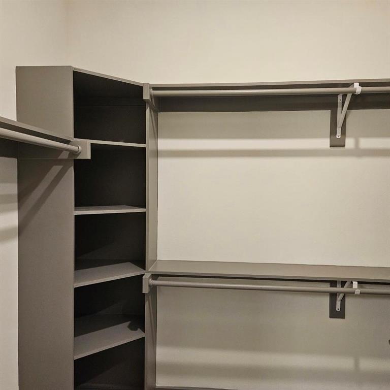 2700 Old Denton Road, Unit 2238 Carrollton, TX 75007 - Photo 17 of 21 Built-in closet system featuring multiple hanging rods, corner shelving, and neutral tone finishes