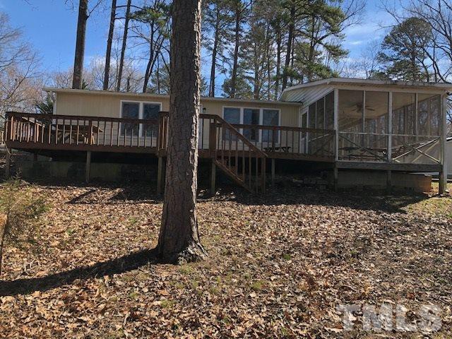 291 Kerr Lake Road Henderson, NC 27537 - Photo 8 of 15 a view of house with a yard and wooden fence