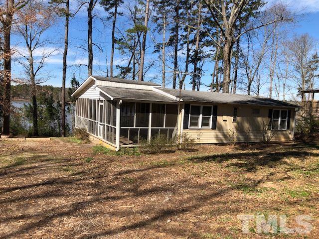 291 Kerr Lake Road Henderson, NC 27537 - Photo 9 of 15 a front view of a house with a garden