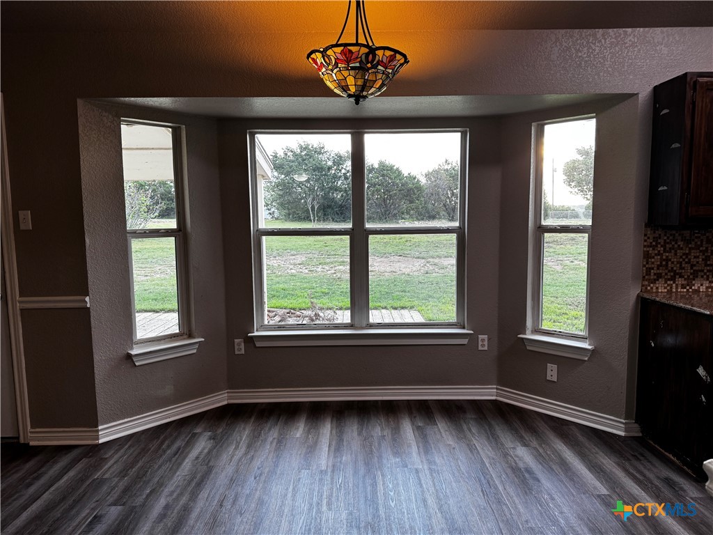 397 County Road 3367 Kempner, TX 76539 - Photo 12 of 47 a view of an empty room with a window and wooden floor