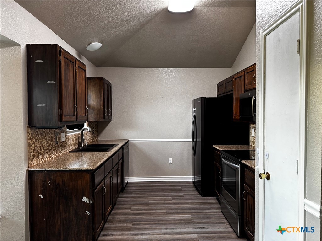 397 County Road 3367 Kempner, TX 76539 - Photo 13 of 47 a kitchen with a sink stove and refrigerator