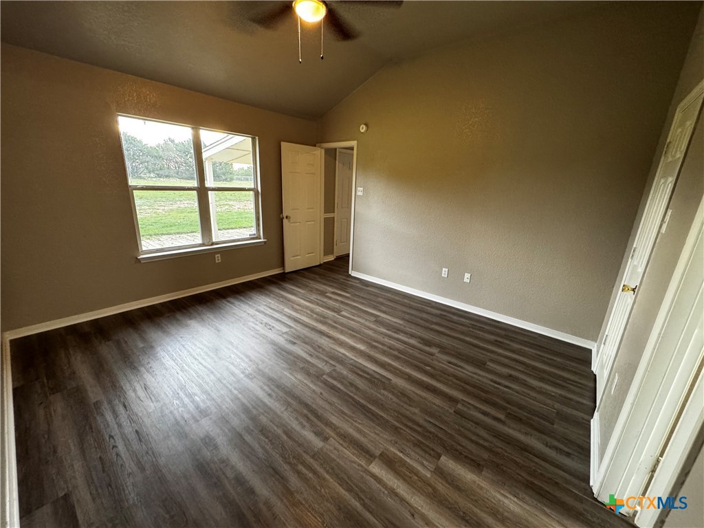 397 County Road 3367 Kempner, TX 76539 - Photo 21 of 47 an empty room with wooden floor chandelier fan and windows
