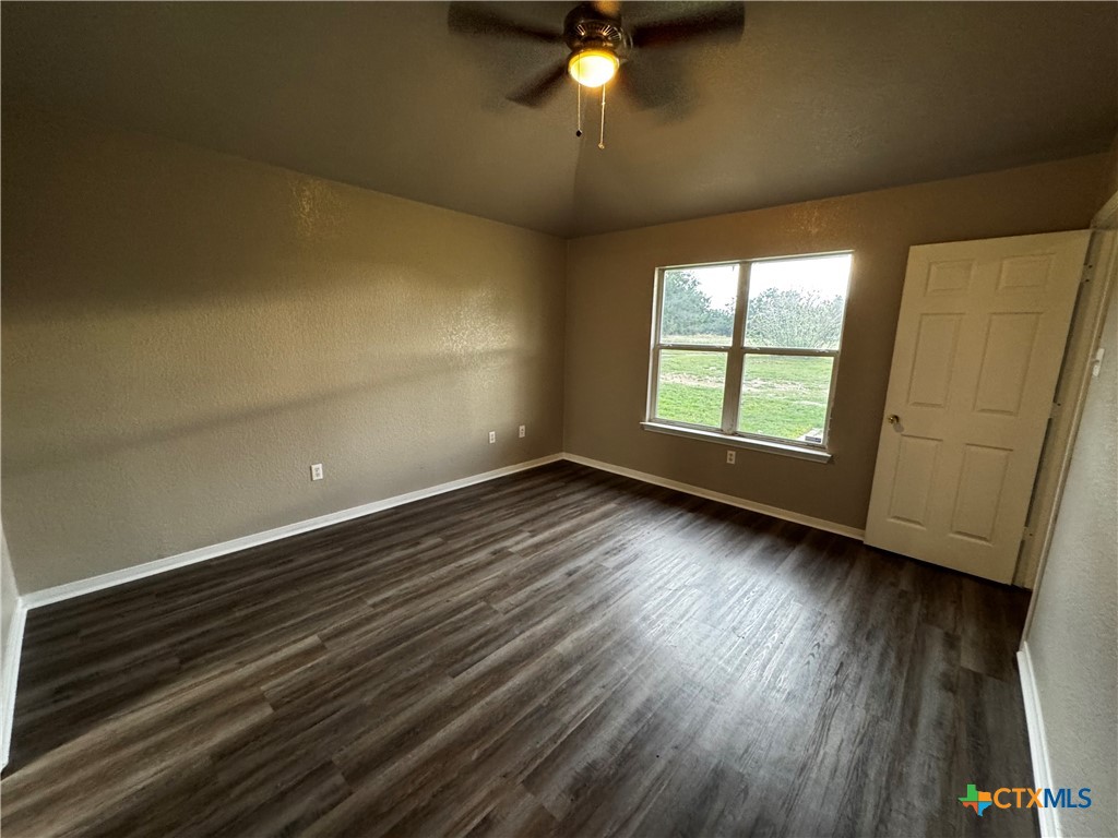 397 County Road 3367 Kempner, TX 76539 - Photo 22 of 47 an empty room with wooden floor and windows