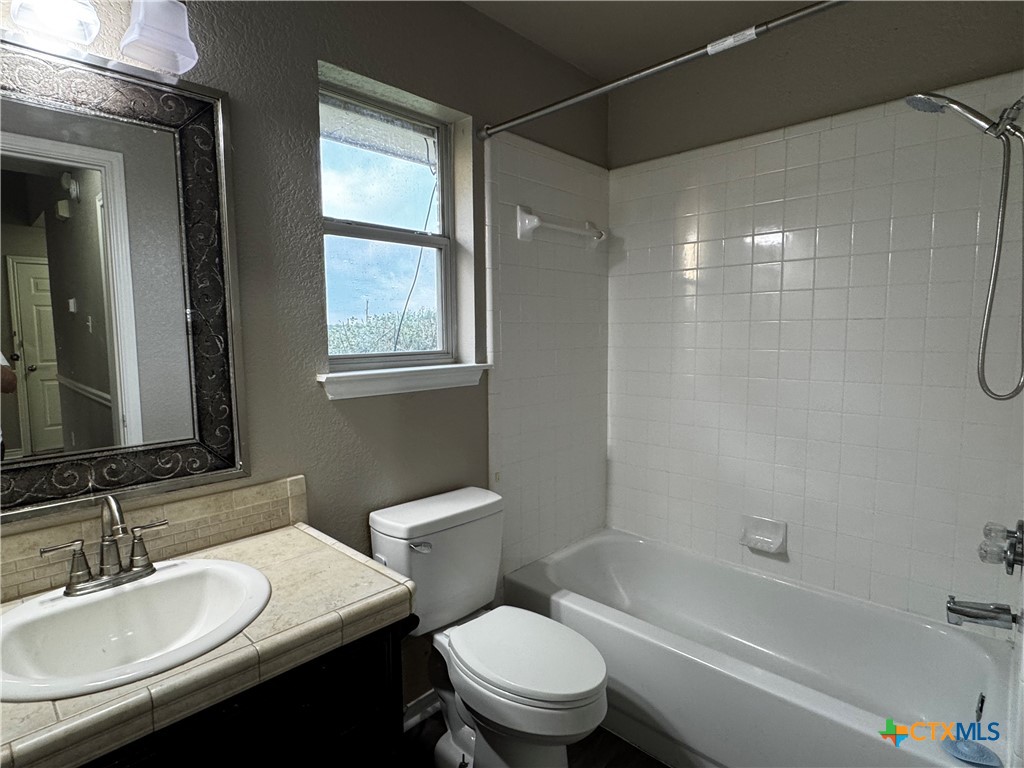 397 County Road 3367 Kempner, TX 76539 - Photo 31 of 47 a bathroom with a sink toilet vanity and shower