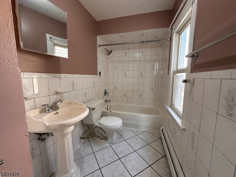 748 Trumbull Street, Unit 2 Elizabeth, NJ 07201 - Photo 7 of 13 a bathroom with a sink a toilet and shower