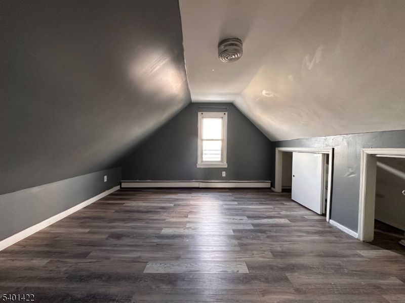 748 Trumbull Street, Unit 2 Elizabeth, NJ 07201 - Photo 9 of 13 a view of an empty room with wooden floor and a window