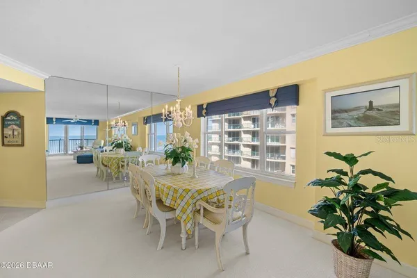 a view of a dining room with furniture and window