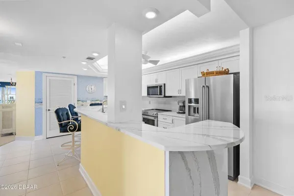 a kitchen with stainless steel appliances a refrigerator and a counter space