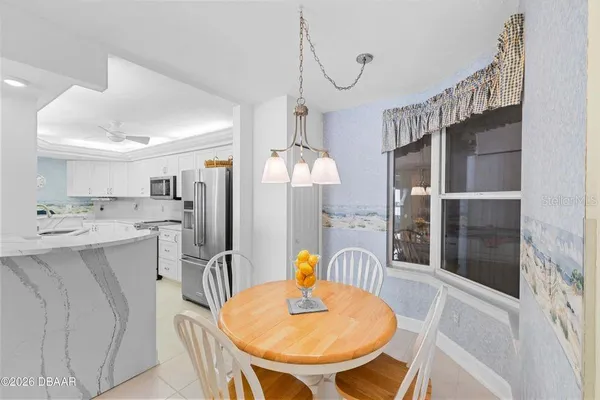a dining room with furniture a window and kitchen view