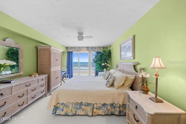 a bedroom with a bed and a dresser with mirror