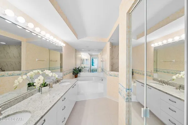 a large white kitchen with a large window