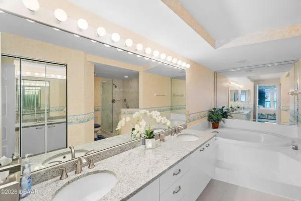 a bathroom with a double vanity sink and a large mirror